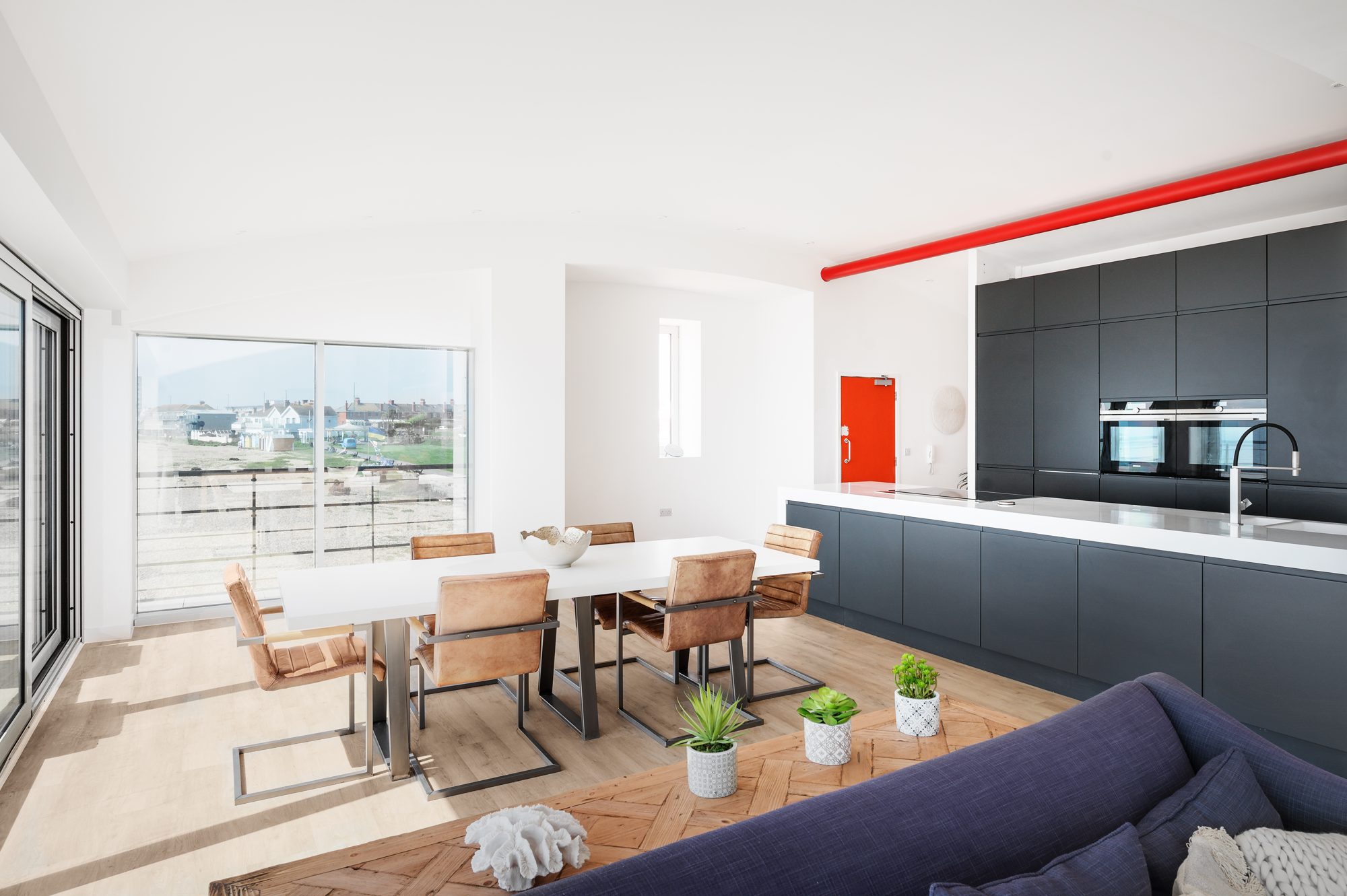 The kitchen and living space of a seafront apartment, kept ready for guests