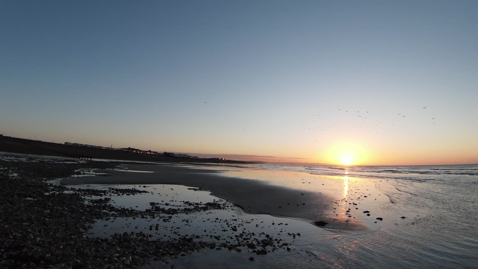 Sunset over the beach at low tide
